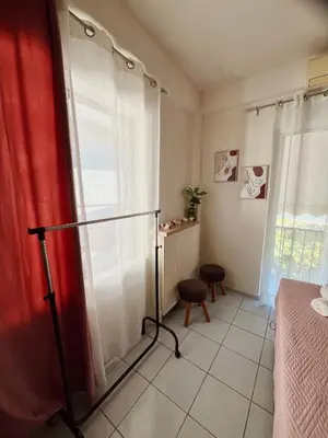 a room with a bed and a red curtain at Yasemi Chania Residences in Chania Town