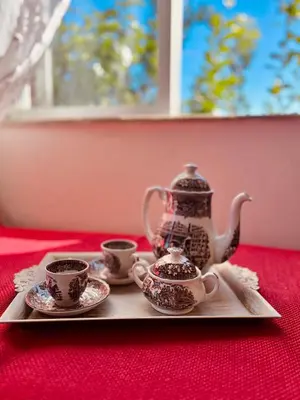 a tray with cups and a tea set on a table at Yasemi Chania Residences in Chania Town