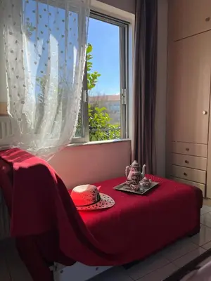 a bedroom with a red table with a window at Yasemi Chania Residences in Chania Town