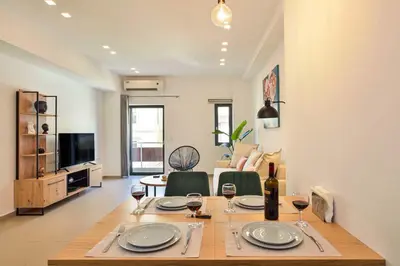 a dining room table with wine glasses on top of it at Alex Downtown Holiday Apartment in Chania Town