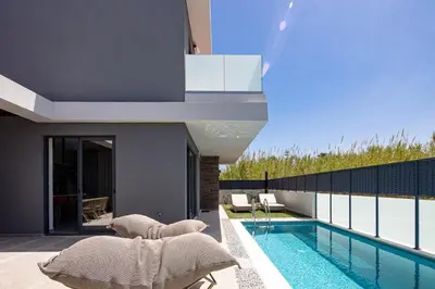 a house with a swimming pool next to a house at VillaSaints I Private Pool Villas, Walk to Beach, BBQ in Chania Town