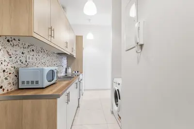 a kitchen with a microwave on a counter next to a refrigerator at Central Bliss Apartment in Chania Town