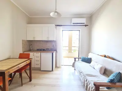 a living room with a couch and a table and a kitchen at Liva apartments in Chania Town