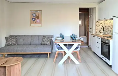 a kitchen and living room with a couch and a table at Liva apartments in Chania Town