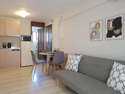 a living room with a couch and a table with chairs at Liva apartments in Chania Town