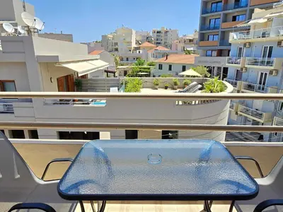 a table on a balcony with a view of a city at Liva apartments in Chania Town