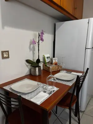 a dining room table with two white plates on it at Lynne's Harmony Chania Beach Studio in Chania Town