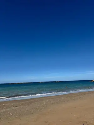 a beach with the ocean and a blue sky at Lynne's Harmony Chania Beach Studio in Chania Town