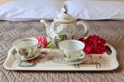 a tray with two cups and a tea set on a bed at VALENA COZY MAISONETTE (15 min-ELAFONISI BEACH) in Élos