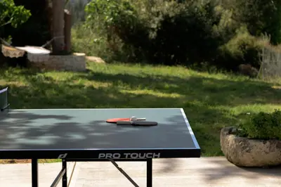 a ping pong table with two phones on top of it at Reflection Villa, Heated Pool & Absolute Seclusion, By ThinkVilla in Chania Town