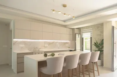 a kitchen with a white island and white stools at Reflection Villa, Heated Pool & Absolute Seclusion, By ThinkVilla in Chania Town