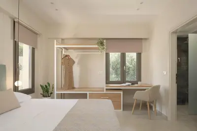 a bedroom with a bed and a desk and a chair at Reflection Villa, Heated Pool & Absolute Seclusion, By ThinkVilla in Chania Town