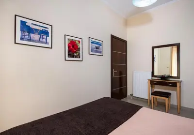 a bedroom with a bed and a desk and a mirror at Socrates Holidays Apt. 1 with Pool near the Beach in Kamisianá