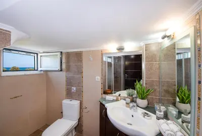 a bathroom with a toilet and a sink at Socrates Holidays Apt. 1 with Pool near the Beach in Kamisianá