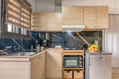 a kitchen with wooden cabinets and a sink at Modern Studio 2 with a Yard in Chania Town