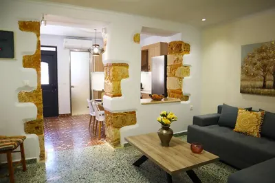 a living room with a couch and a table at Dimitriοs Stone House in Chania Town