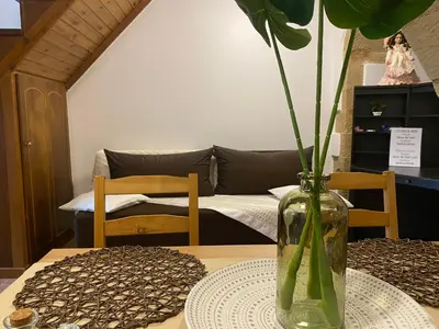 a table with a vase with a plant in it at Skaros Cottage in Chania Town