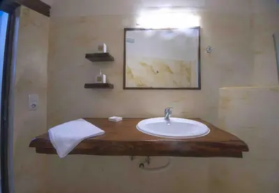 a bathroom with a sink on a wooden counter at Skaros Cottage in Chania Town