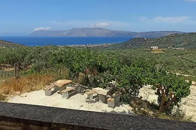 a group of benches sitting on the sand near the ocean at Mulberry Hill - amazing panoramic views - Kissamos in Kissamos