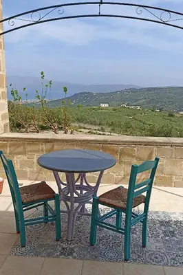 a table and two chairs next to a table and a table and chairs at Mulberry Hill - amazing panoramic views - Kissamos in Kissamos