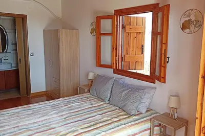 a bedroom with a bed and a window at Mulberry Hill - amazing panoramic views - Kissamos in Kissamos