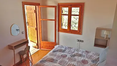 a bedroom with a bed and a desk and a window at Mulberry Hill - amazing panoramic views - Kissamos in Kissamos