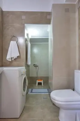 a bathroom with a white toilet and a shower at VALENA STYLISH HOME (15 min TO ELAFONISI BEACH) in Élos