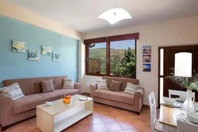 a living room with two couches and a table at VALENA STYLISH HOME (15 min TO ELAFONISI BEACH) in Élos