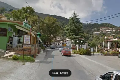 a street in a small town with cars driving down the street at VALENA STYLISH HOME (15 min TO ELAFONISI BEACH) in Élos