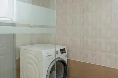 a washing machine in a corner of a room at Mystique Sunset View in Chania Town