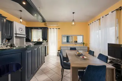a kitchen with a table and chairs in a room at Mystique Sunset View in Chania Town