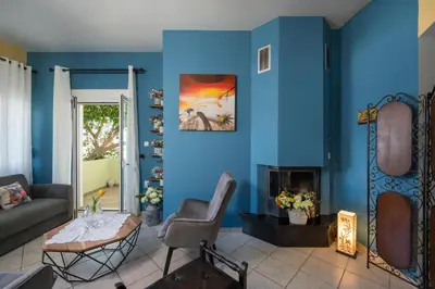 a living room with a blue wall at Mystique Sunset View in Chania Town