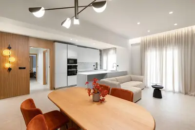 a living room with a table and a couch at CRETA ELENA SUITE in Chania Town