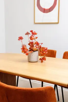 a vase of flowers sitting on a wooden table at CRETA ELENA SUITE in Chania Town