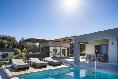 a house with a swimming pool and a patio at Virtus in Mare in Tsivarás