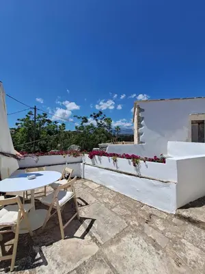 a patio with a table and chairs on a building at Villa ABBA in Plaka