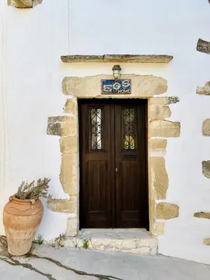 a door of a building with a pot in front of it at Villa ABBA in Plaka