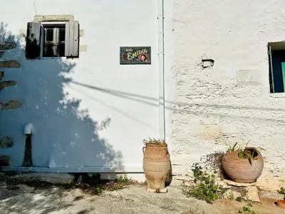 two potted plants sitting on the side of a building at Villa ABBA in Plaka