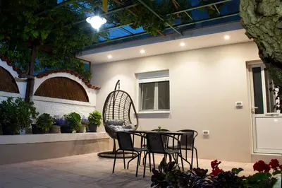 a patio with chairs and a table in a building at Garden house in Kissamos