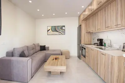a living room with a couch and a table at Garden house in Kissamos