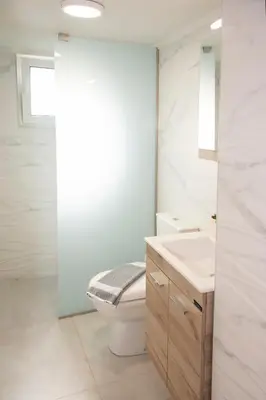 a white bathroom with a toilet and a sink at Garden house in Kissamos