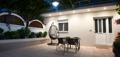 a patio with a table and chairs in front of a building at Garden house in Kissamos