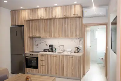 a kitchen with wooden cabinets and a sink at Garden house in Kissamos