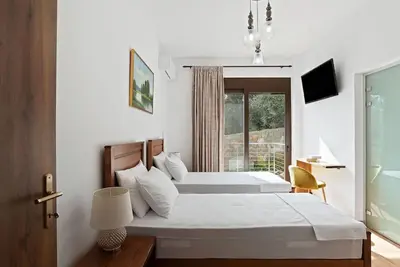 a bedroom with a large bed and a window at Kera Green Villa in Kalyves