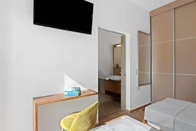 a living room with a television on a wall at Kera Green Villa in Kalyves