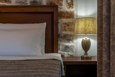 a bedroom with a bed and a lamp on a table at Kera Green Villa in Kalyves