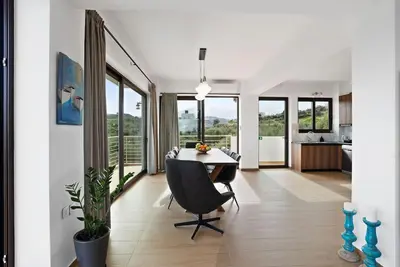 a kitchen and dining room with a table and chairs at Kera Green Villa in Kalyves