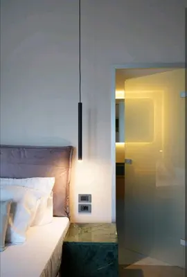 a bedroom with a bed with a glass door at Riviera Seafront Balcony in Evthími