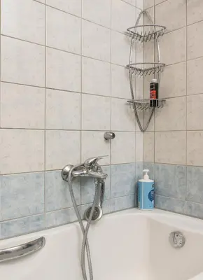 a bath tub with a shower head in a bathroom at Urban Oasis Central in Chania Town