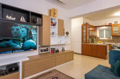 a living room with a large flat screen tv at Urban Oasis Central in Chania Town
